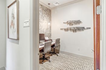 A dining room with a table and chairs and a wall with weapons on the wall